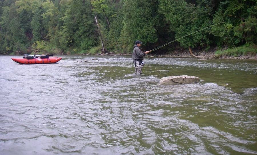 An angler on a guided drift boat trip in Ontario