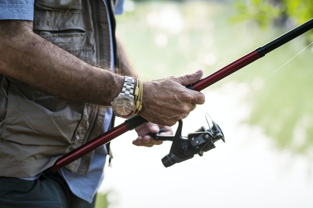 man fishing by a lake e1625646233819